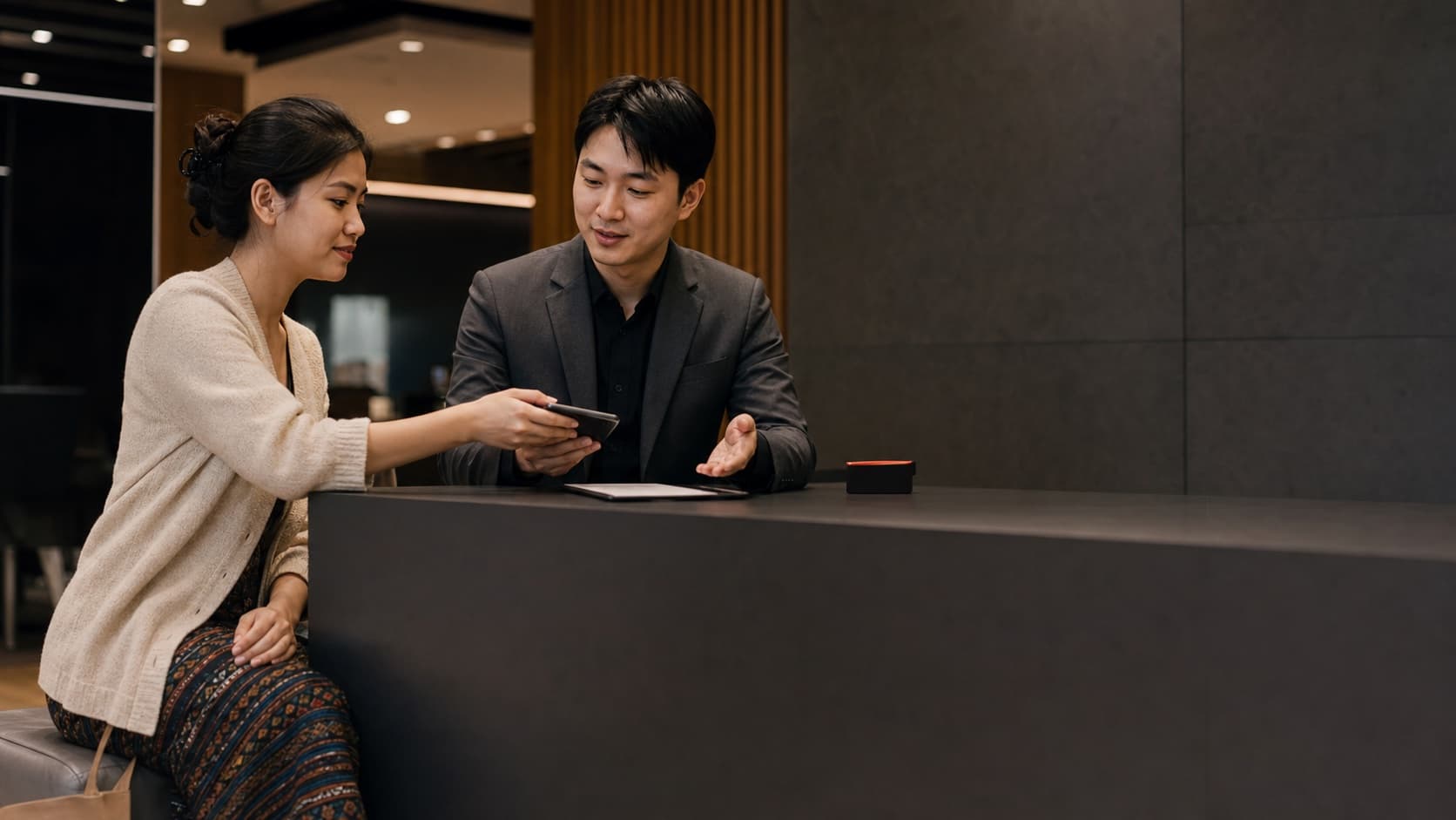 A customer discussing telecom options with an adviser